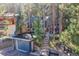 Charming blue home nestled among tall trees, featuring a garage, and stone stairway at 26378 S End Rd, Kittredge, CO 80457