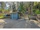 Exterior view of the garage, with a red door, and stone stairway leading to the house at 26378 S End Rd, Kittredge, CO 80457