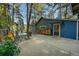 Outdoor patio with seating, a table, and stacked firewood next to the blue home at 26378 S End Rd, Kittredge, CO 80457