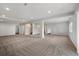 Spacious finished basement with an open layout, carpeted floors, and recessed lighting at 4421 Tanager Trl, Broomfield, CO 80023