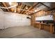 Spacious unfinished basement with workbench and visible ceiling joists, ideal for customization at 4421 Tanager Trl, Broomfield, CO 80023