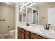 Bathroom featuring a double vanity, ample mirror space, and a separate toilet area at 4421 Tanager Trl, Broomfield, CO 80023