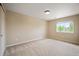 Cozy bedroom with neutral walls, a large window, and carpet flooring at 4421 Tanager Trl, Broomfield, CO 80023
