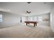 Large bonus room perfect for entertaining, complete with a pool table, ceiling fan, and lots of light at 4421 Tanager Trl, Broomfield, CO 80023
