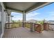 Covered deck with decorative lighting and wood railings, perfect for outdoor relaxation and entertainment at 4421 Tanager Trl, Broomfield, CO 80023