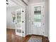 Elegant foyer with hardwood floors, white trim, a front door featuring decorative glass and a nearby room behind french doors at 4421 Tanager Trl, Broomfield, CO 80023