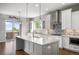 Stunning kitchen with a large island, modern appliances, white cabinets, stylish backsplash and access to a deck at 4421 Tanager Trl, Broomfield, CO 80023