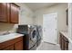Functional laundry room with modern washer, dryer, and ample counter space for folding at 4421 Tanager Trl, Broomfield, CO 80023