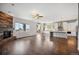 Open floor plan with hardwood floors connecting the living room, kitchen, and dining area at 4421 Tanager Trl, Broomfield, CO 80023