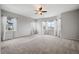 Bright main bedroom with neutral carpet, a ceiling fan, and multiple windows with lots of natural light at 4421 Tanager Trl, Broomfield, CO 80023