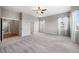 A large bedroom with a ceiling fan, neutral carpet and lots of space and natural light at 4421 Tanager Trl, Broomfield, CO 80023