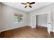 Bright room showcasing hardwood floors, neutral walls, a ceiling fan, and windows allowing natural light to illuminate the space at 4421 Tanager Trl, Broomfield, CO 80023