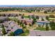 Aerial view of townhomes, featuring colorful exteriors, green space, and mountain views at 351 Montgomery Dr, Erie, CO 80516