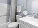 Well-lit bathroom features a shower-tub combo, white subway tiles, and modern gray paint at 351 Montgomery Dr, Erie, CO 80516