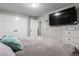 The bedroom features a mounted television, closet, and relaxing neutral color palette at 12131 Melody Dr # 101, Denver, CO 80234