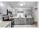 Modern kitchen with gray cabinets and stainless steel appliances at 12131 Melody Dr # 101, Denver, CO 80234