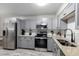 Modern kitchen features gray cabinets, stainless appliances, and stone countertops at 12131 Melody Dr # 101, Denver, CO 80234