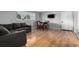 Comfortable living room with gray sofa and dining area at 12131 Melody Dr # 101, Denver, CO 80234