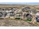 An aerial view features modern homes with solar panels and fenced yards in a desert landscape at 9559 Yucca Way, Arvada, CO 80007