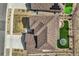 A bird's eye view reveals a home with a well-maintained roof, green lawn, and trampoline at 9559 Yucca Way, Arvada, CO 80007