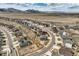 Stunning aerial view of a residential community with mountain views and modern homes featuring solar panels at 9559 Yucca Way, Arvada, CO 80007