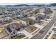 An aerial view shows a neighborhood with mountain views, paved roads, and well-maintained lawns at 9559 Yucca Way, Arvada, CO 80007