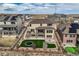 Aerial view showcasing the home's backyard with trampoline, fire pit, and putting green within a fenced yard at 9559 Yucca Way, Arvada, CO 80007
