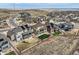 An aerial view shows homes with fenced yards, solar panels and patios in a desert community at 9559 Yucca Way, Arvada, CO 80007