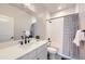 Well-lit bathroom featuring a shower-tub combo, modern vanity, and decorative mirror at 9559 Yucca Way, Arvada, CO 80007