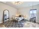 Bedroom with a unique hanging chair, patterned rug, and modern lighting fixture at 9559 Yucca Way, Arvada, CO 80007