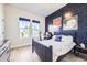 Bedroom featuring a celestial-themed accent wall, desk, and comfortable sleeping area at 9559 Yucca Way, Arvada, CO 80007