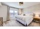 Cozy bedroom with geometric accent wall, large window and comfortable bedding for a restful space at 9559 Yucca Way, Arvada, CO 80007