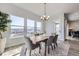 Bright dining area with large windows, hardwood floors, modern chandelier, and mountain views at 9559 Yucca Way, Arvada, CO 80007