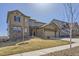 Handsome home with a stone and siding exterior, three-car garage, and drought-resistant landscaping at 9559 Yucca Way, Arvada, CO 80007
