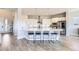 Beautiful kitchen island with bar seating, hardwood floors, and stainless steel appliances at 9559 Yucca Way, Arvada, CO 80007