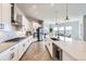 Bright, modern kitchen with an island, stainless steel appliances, and hardwood floors at 9559 Yucca Way, Arvada, CO 80007