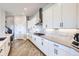 Contemporary kitchen featuring white cabinets, granite countertops, stainless steel appliances, and hardwood floors at 9559 Yucca Way, Arvada, CO 80007