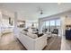 Open-concept living room with modern furnishings, hardwood floors, and sliding doors to a balcony at 9559 Yucca Way, Arvada, CO 80007