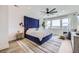 Spacious main bedroom with a large blue headboard, city views, and modern decor at 9559 Yucca Way, Arvada, CO 80007
