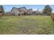 Large backyard with green grass, landscaping and trees, and wooden fence at 16645 W 2Nd Ave, Golden, CO 80401