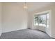 Bright room with large windows, neutral carpet, and white walls, perfect for customization at 16645 W 2Nd Ave, Golden, CO 80401