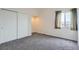 Cozy bedroom with neutral walls and carpet, closet, and a window showcasing mountain views at 16645 W 2Nd Ave, Golden, CO 80401
