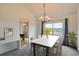 Bright dining room features modern chandelier, large window, and beautiful mountain view at 16645 W 2Nd Ave, Golden, CO 80401