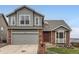 Charming two-story home featuring a brick and gray wood exterior with a two-car garage at 16645 W 2Nd Ave, Golden, CO 80401