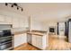 Bright kitchen features white cabinets, stainless steel appliances, and an open view to the living room at 16645 W 2Nd Ave, Golden, CO 80401