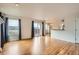 Open living room features hardwood floors, fireplace, large windows and sliding glass doors to balcony, and kitchen access at 16645 W 2Nd Ave, Golden, CO 80401