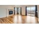 Living room with hardwood floors, fireplace, and sliding glass doors leading to a deck with scenic mountain views at 16645 W 2Nd Ave, Golden, CO 80401