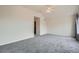 Empty main bedroom with vaulted ceiling, ceiling fan, large windows with views, and neutral carpet at 16645 W 2Nd Ave, Golden, CO 80401