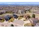 Wide aerial shot of the neighborhood showcasing homes with mountain views in the background at 9239 Erminedale Dr, Lone Tree, CO 80124
