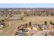 Expansive aerial view of a neighborhood with power lines cutting through open fields and cityscape at 9239 Erminedale Dr, Lone Tree, CO 80124